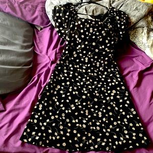 a super cute black dress with white dandelions on it